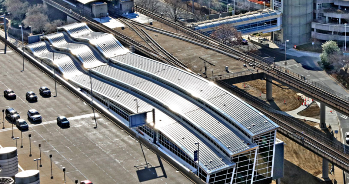 Aerial view of rail terminal connected to airport.