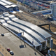 Aerial view of rail terminal connected to airport.