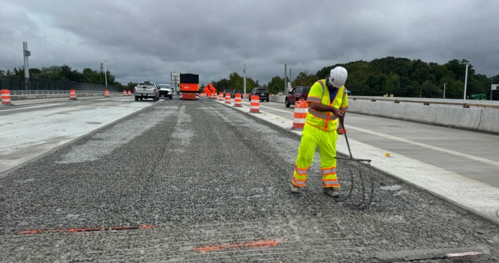 A worker in safety gear working on preparation for concrete pouring construction efforts.