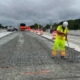 A worker in safety gear working on preparation for concrete pouring construction efforts.