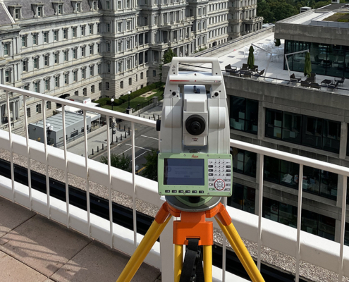 Leica total station on a building rooftop surveying historic Mills Building in Washginton, DC