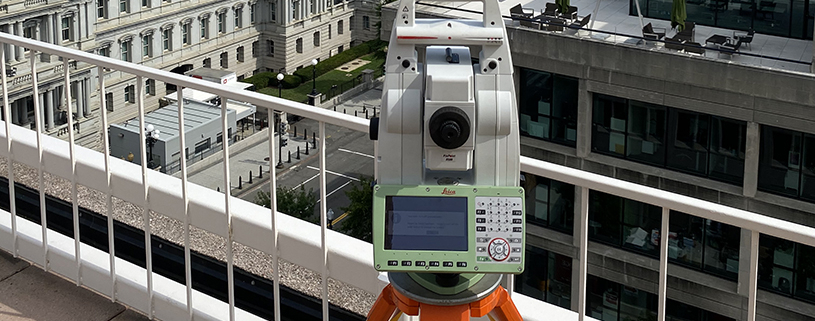 Leica total station on a building rooftop surveying historic Mills Building in Washginton, DC