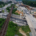 Aerial view of a highway interchange with multiple overpasses, a railway line, cars in motion, and ongoing road construction work.