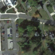 Aerial view of a road intersection filled with cars and adjacent parking lot